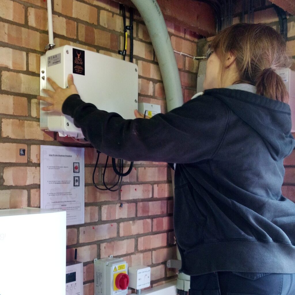 Solar inverter installed on a garage wall in Essex with professional electrical connections and safety isolators