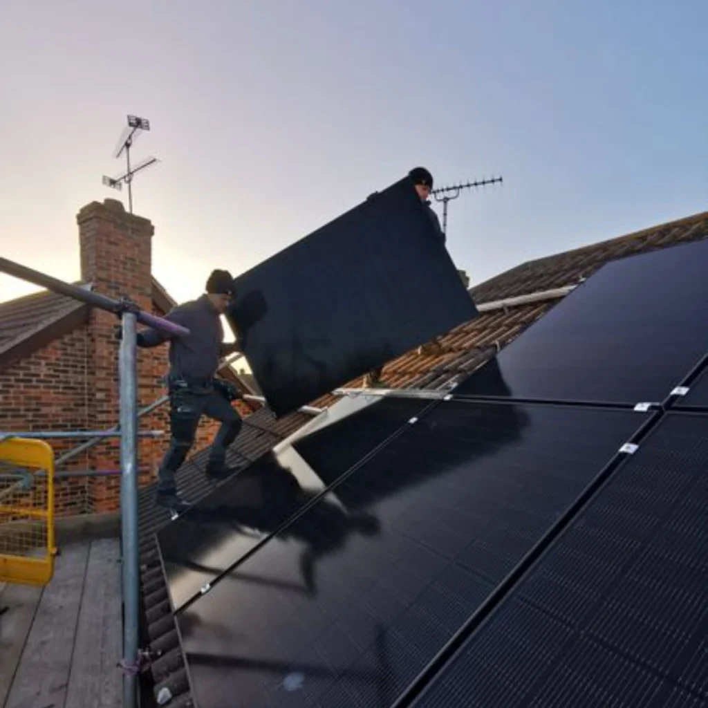 Solar panel being installed on a tiled roof in Essex by professional installers using scaffolding