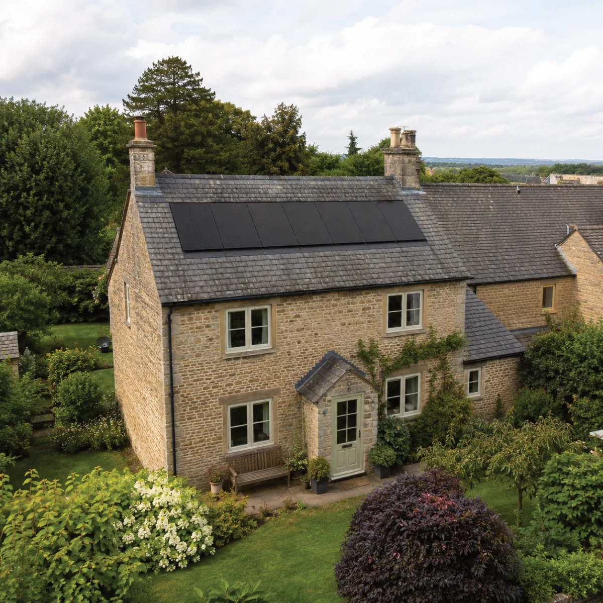 All-black solar panels installed on a traditional British house with a natural slate roof.